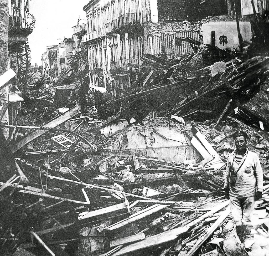 A Russian sailor clears rubble after the Messina earthquake.