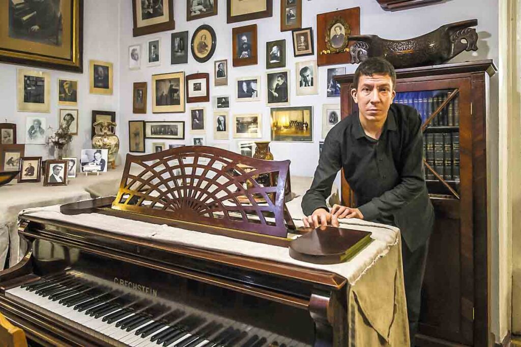 Museum director Andrey Gaponov, himself a Gnesin graduate, at the Bechstein piano that Rachmaninoff helped Elena choose