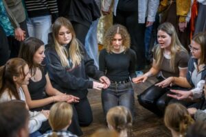 The kissing game "Barrel." The girls sit in the center of the circle. When the chant ends, the lads will rush over to kiss them